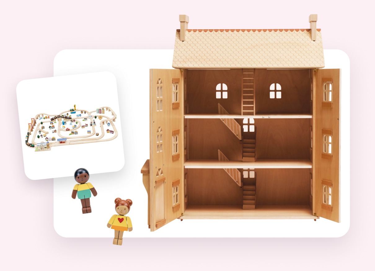 A low table with a wooden train set, a dollhouse and small figures